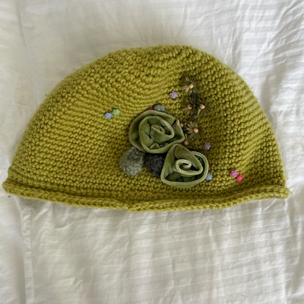 Knit leaf green hat with floral embellishments